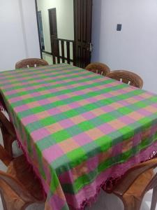 a table with a checkered table cloth on it at Trailside Homestay in Badulla