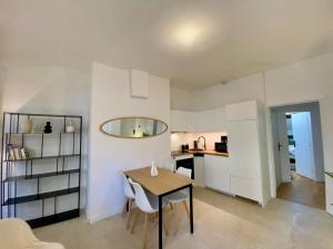 a kitchen and dining room with a table and chairs at Les Jardins Suspendus in Lyon