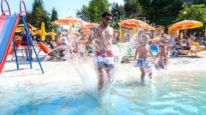 a group of people playing in a water park at Erica in Folgaria