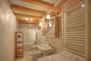 a bathroom with a sink and a toilet at La Gaubertière in Saint-Paul-du-Bois