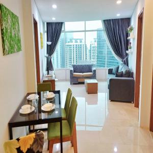 a living room with a dining table and a living room at vortex klcc by IOI HOME management in Kuala Lumpur