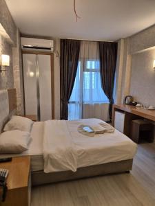 a hotel room with a bed and a window at Bulut Hotel in Pamukkale
