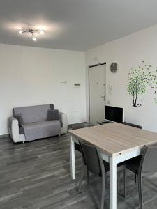 a living room with a table and a couch at Paky' S House in Policoro