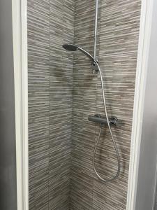 a shower with a shower head in a bathroom at Paky' S House in Policoro +10 photos