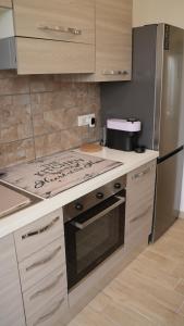 a kitchen with a stove and a refrigerator at Sky Balcony - Milano Sud- vicino Humanitas e forum Assago in Rozzano