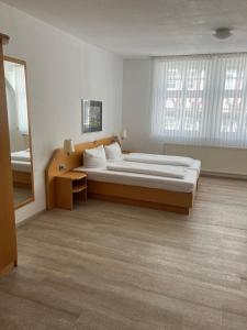 a bedroom with a large bed and a large window at Hotel Kaiserpfalz in Fritzlar