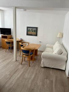 a living room with a couch and a table at Hotel Kaiserpfalz in Fritzlar