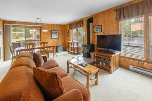 a living room with a couch and a flat screen tv at Mountain House, A Vail Resorts Property in Keystone