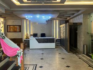 a lobby with a reception desk in a building at Hotel V Square in Lucknow