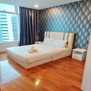 a bedroom with a bed with a teddy bear on it at vortex klcc by IOI HOME management in Kuala Lumpur +24 photos