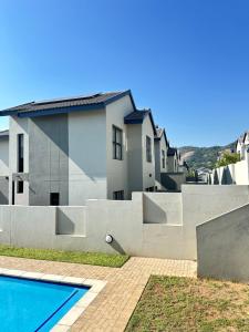 a house with a swimming pool in front of it at Elusive Haven in Nelspruit