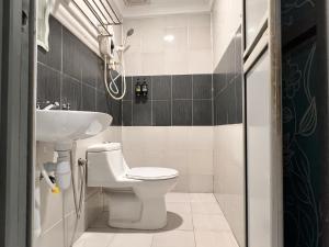 a bathroom with a toilet and a sink at Hotel Double Star Klia in Sepang