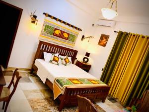 a bedroom with a bed and a table at Asoria Luxe Resort in Kegalle
