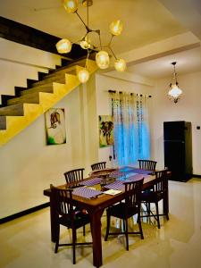 a dining room with a wooden table and chairs at Asoria Luxe Resort in Kegalle