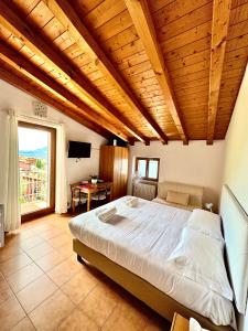 a bedroom with a large bed with a wooden ceiling at Monja Camping Village in Brenzone sul Garda