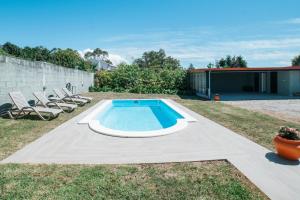 a swimming pool in the backyard of a house at Casa de Salgueiros in Canidelo