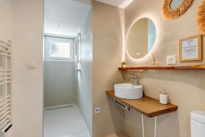 a bathroom with a sink and a mirror at Villa Alekatele in La Tranche-sur-Mer +27 photos