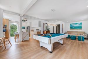 a living room with a pool table in it at Villa Alekatele in La Tranche-sur-Mer