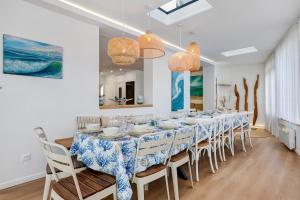 a dining room with a long table and chairs at Villa Alekatele in La Tranche-sur-Mer