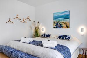 a bedroom with a large bed with towels on it at Villa Alekatele in La Tranche-sur-Mer