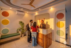 a group of people standing at a counter in a room at Zostel Jaipur, MI Road in Jaipur
