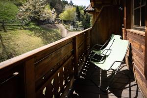 a porch with two chairs and a view of a field at Lechnerhof in Plaus