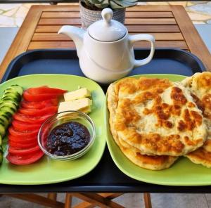 a tray of food with eggs and vegetables on a table at Amari Rooms in Gjirokastër