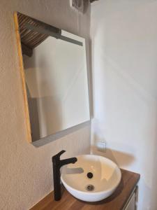 a bathroom sink with a mirror on the wall at Casa Nossa in Azinhal +9 photos