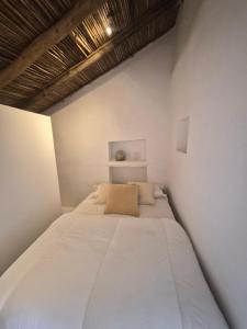 a white bedroom with a large bed in it at Casa Nossa in Azinhal