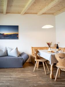 a living room with a blue couch and a table at Lechnerhof in Plaus
