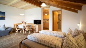 a living room with two beds and a dining room at Lechnerhof in Plaus