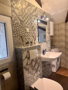 a small bathroom with a sink and a toilet at Old Town Apartment in Krk +31 photos