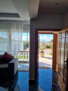 a living room with blue flooring and a view of the ocean at Plage El Haouzia in El Jadida