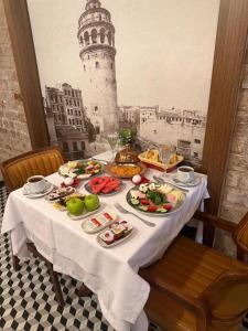 a table with food on it with a lighthouse in the background at Center Hill Hotel in Istanbul