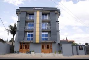 a gray building with a balcony on top of it at Kika resort hotel in Arusha