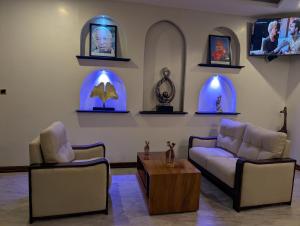 a living room with two couches and a table at Kika resort hotel in Arusha
