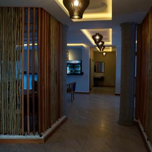 a hallway of a building with a table and a room at Kika resort hotel in Arusha