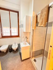 a bathroom with a toilet and a sink and a shower at Milano 2, cozy, Wi-Fi, minimum 2 nights in Segrate