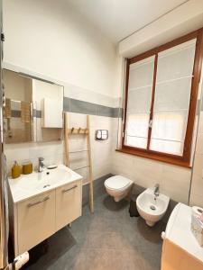 a bathroom with a sink and a toilet and a window at Milano 2, cozy, Wi-Fi, minimum 2 nights in Segrate