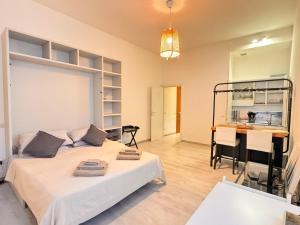 a room with two beds and a table in it at Milano 2, cozy, Wi-Fi, minimum 2 nights in Segrate
