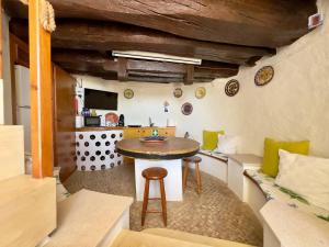 a living room with a table and a kitchen at Moinhos Da Guimaroa in Cadafais