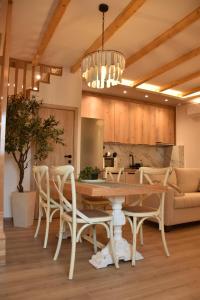 a dining room and kitchen with a table and chairs at Pelagio Residence in Samothraki