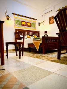 a bedroom with a bed and a chair in a room at Asoria Luxe Resort in Kegalle +32 photos
