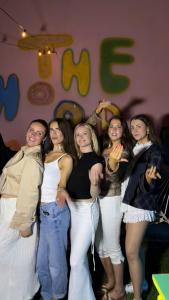 a group of girls standing in front of a wall at The Hood Hostel & Day Tours in Shkodër