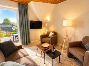 a living room with two couches and a table at Haus Nige Wark - Ferienwohnungen in Cuxhaven