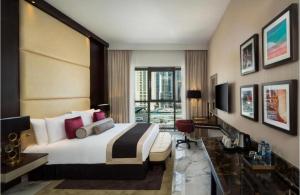 a hotel room with a large bed and a desk at Hotel Vasudha Inn-Near International Airport Delhi in New Delhi +20 photos
