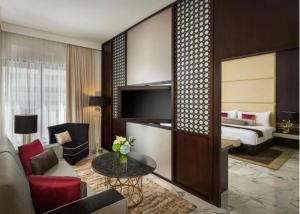 a hotel room with a bed and a living room at Hotel Vasudha Inn-Near International Airport Delhi in New Delhi