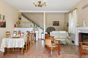 a kitchen and dining room with a table and chairs at Les Malvaux - Chambres d'hôtes in Huriel