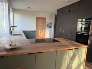 a kitchen with a wooden counter top with a sink at Hugleikshus in Hvolsvöllur