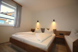 a bedroom with two beds and a window at Apartments Luidold in Schladming